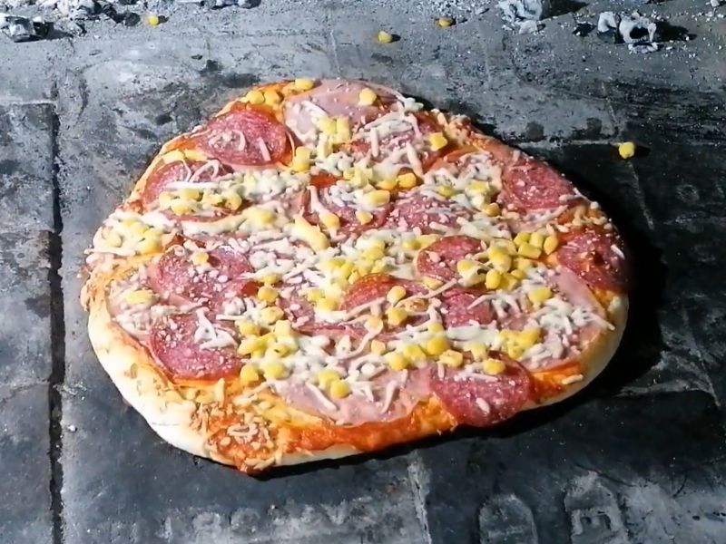 homemade Italian pizza prepared in a wood-fired oven.